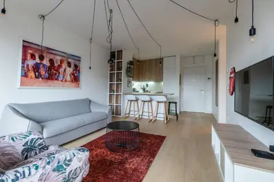 a living room with a couch and a table at HostGost Selected Suites - K District in Belgrade