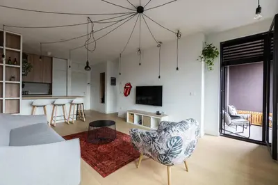 a living room with a couch and a table at HostGost Selected Suites - K District in Belgrade