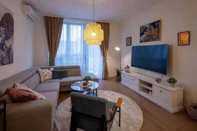 a living room with a couch and a flat screen tv at Belgrade Waterfront Lux in Belgrade
