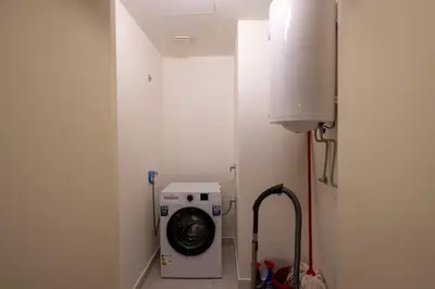 a washer and dryer in a bathroom with a wall at Belgrade Waterfront Lux in Belgrade