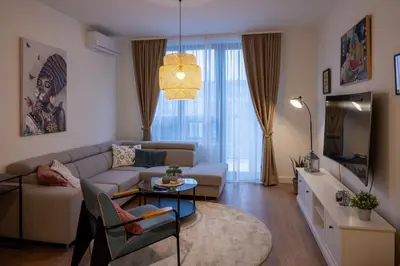 a living room with a couch and a table at Belgrade Waterfront Lux in Belgrade