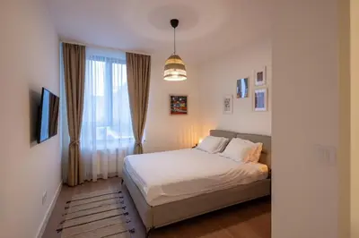 a small bedroom with a bed and a window at Belgrade Waterfront Lux in Belgrade