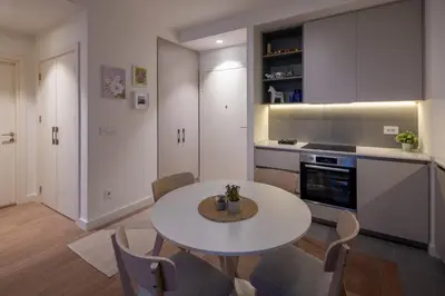 a kitchen with a table and chairs in a room at Belgrade Waterfront Lux in Belgrade