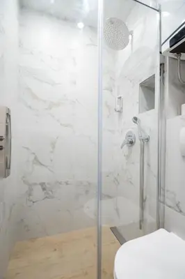 a bathroom with a glass shower with a toilet at Boho House Skadarlija in Belgrade