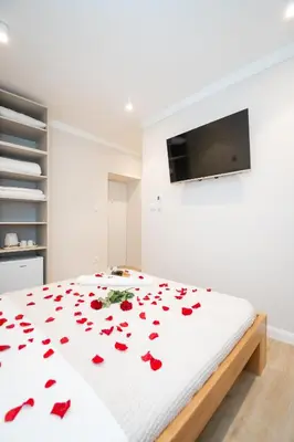 a bedroom with a bed with red roses on it at Boho House Skadarlija in Belgrade
