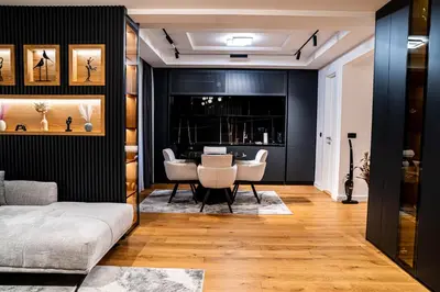 a living room with a table and chairs at Brilijant Lux Apartman in Arandjelovac