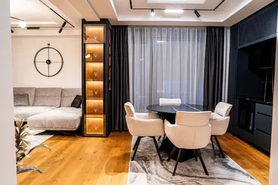a living room with a table and chairs at Brilijant Lux Apartman in Arandjelovac