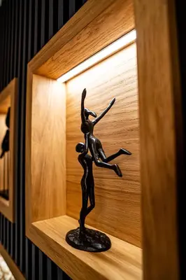 a bronze statue of a woman dancing in a clock at Brilijant Lux Apartman in Arandjelovac