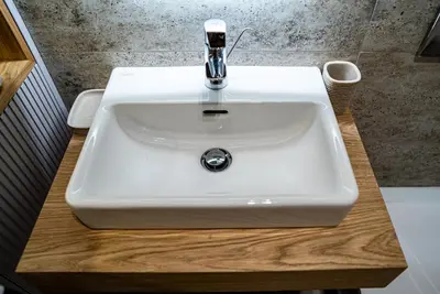 a white sink with a faucet in a bathroom at Brilijant Lux Apartman in Arandjelovac