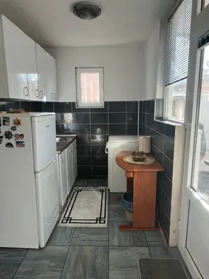 a kitchen with a refrigerator and a table in it at City Vibe in Belgrade