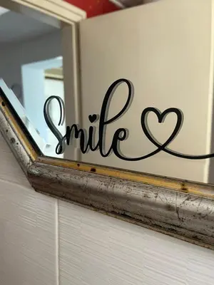 a mirror with the word smile written on it at City Vibe in Belgrade