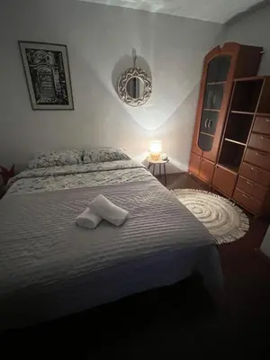 a bedroom with a bed with two towels on it at City Vibe in Belgrade