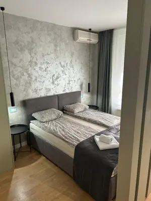 a bedroom with two beds and a wall at Belvil 5 in Belgrade
