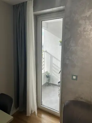 a sliding glass door with a view of a balcony at Belvil 5 in Belgrade