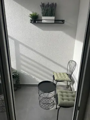 a room with two chairs and a table and a shelf at Belvil 5 in Belgrade