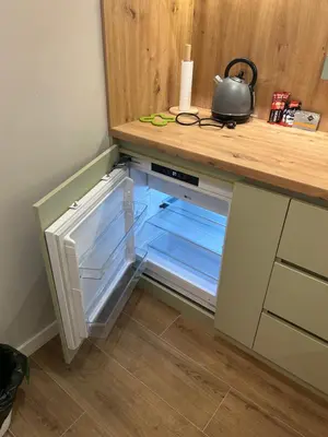 an empty refrigerator with its door open in a kitchen at Belvil 5 in Belgrade