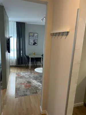 a hallway with a dining room and a table at Belvil 5 in Belgrade