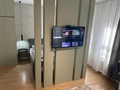 a flat screen tv on a wall in a room at Belvil 5 in Belgrade