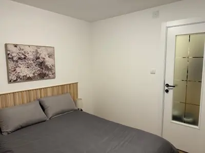 a bedroom with a bed and a painting on the wall at Romero Velvet Nights in Belgrade
