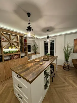 a kitchen with a large island with a wooden counter top at Romero Velvet Nights in Belgrade