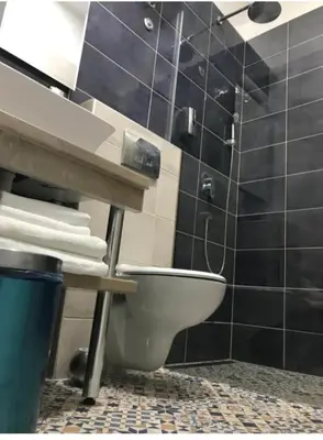 a bathroom with a toilet and a sink at Fine Plus in Belgrade