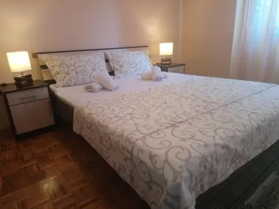 a bedroom with a large white bed with two lamps at Bohemian Rhapsody NBG in Belgrade