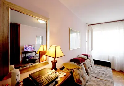 a living room with a mirror and a telephone at Bohemian Rhapsody NBG in Belgrade