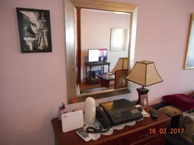 a room with a desk with a telephone and a mirror at Bohemian Rhapsody NBG in Belgrade