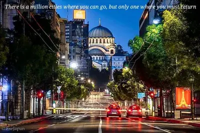 a city street at night with cars on the road at Bohemian Rhapsody NBG in Belgrade