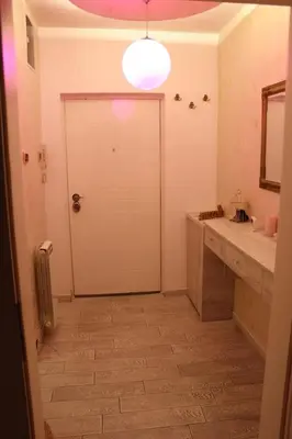 a bathroom with a white door and a sink at Pinky Belgrade Apartment in Belgrade