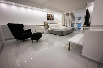 a bedroom with a bed and a couch and a chair at Aries apartment in Belgrade in Belgrade