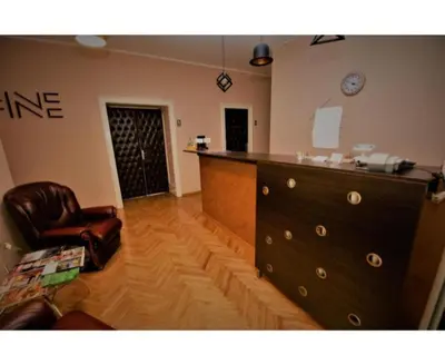 a living room with a dresser and a chair at Fine Plus in Belgrade