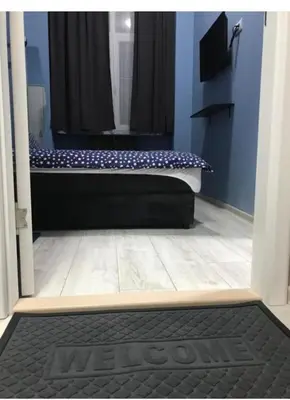 a door to a bathroom with a tub and a shower at Fine Plus in Belgrade