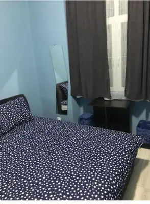 a bedroom with a bed and a window at Fine Plus in Belgrade