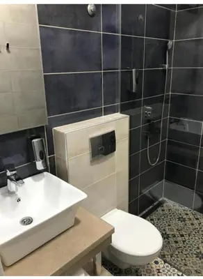 a bathroom with a white toilet and a sink at Fine Plus in Belgrade