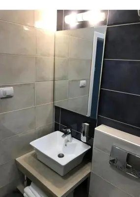 a bathroom with a white sink and a mirror at Fine Plus in Belgrade