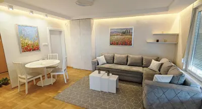 a living room with a couch and a table at Arena Lux apartment in Belgrade