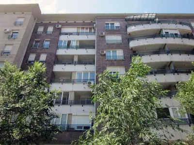 an apartment building with trees in front of it at Arena Lux apartment in Belgrade