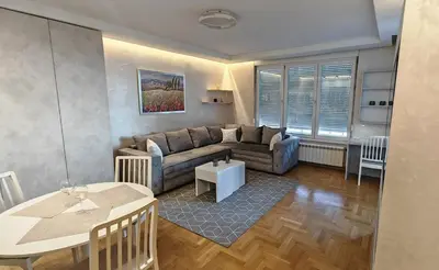 a living room with a couch and a table at Arena Lux apartment in Belgrade