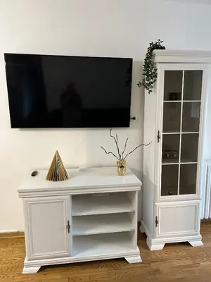 a white entertainment center with a flat screen tv on a wall at Costa apt 3 bedrooms Ideal for Groups Near Arena in Belgrade