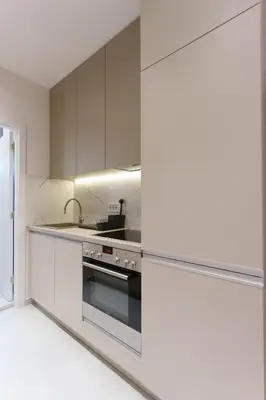 a kitchen with white cabinets and a stove top oven at Elysian in Belgrade