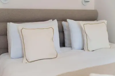 two pillows sitting on top of a bed at Elysian in Belgrade