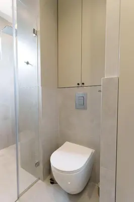 a bathroom with a toilet and a glass shower at Elysian in Belgrade