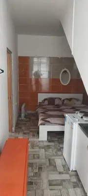 a small room with a bed and a kitchen at Small apartment with private bathrooms STRONG INTERNET in Belgrade