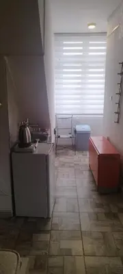 a room with a kitchen with a table and a window at Small apartment with private bathrooms STRONG INTERNET in Belgrade