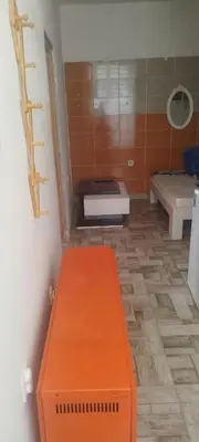 a bathroom with an orange bench in a room at Small apartment with private bathrooms STRONG INTERNET in Belgrade