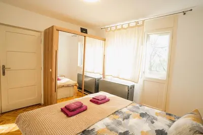 a bedroom with a bed with two towels on it at VP apartment in Belgrade
