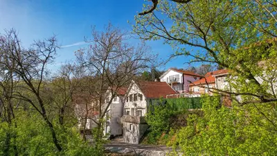 an old house on a hill with trees at VP apartment in Belgrade