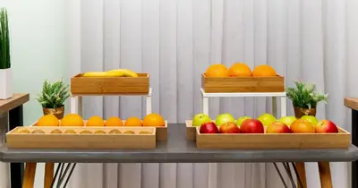 three wooden baskets of fruit on a table at Garni Hotel Mint in Belgrade