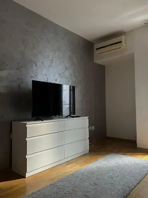 a living room with a flat screen tv on a dresser at Apartman Tara1 in Belgrade